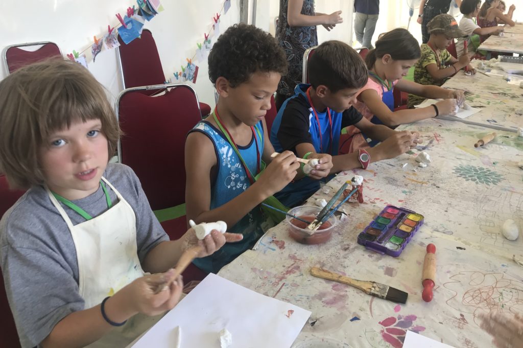 art camp kids making, clay modeling with  art teacher spramani elaun in bali