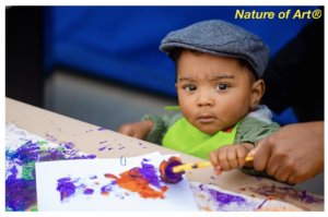 little child painting with tempera paint, book guide